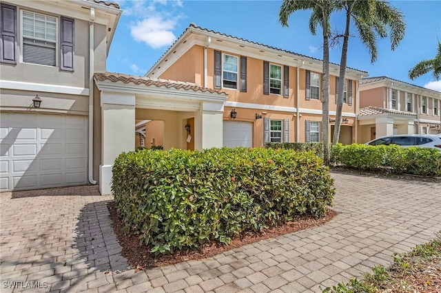 5677 Cove Cir, Naples, FL 34119 - multi unit property featuring a tile roof, stucco siding, and driveway