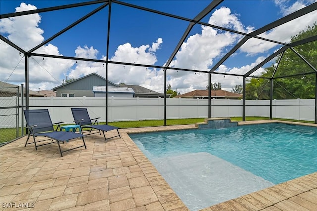 view of swimming pool with glass enclosure, a patio area, and a fenced in pool