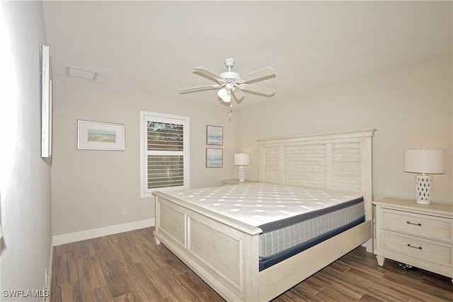 bedroom with ceiling fan, baseboards, and dark wood finished floors