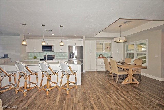 kitchen featuring stainless steel appliances, light countertops, and visible vents