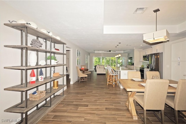 dining room with visible vents and wood finished floors