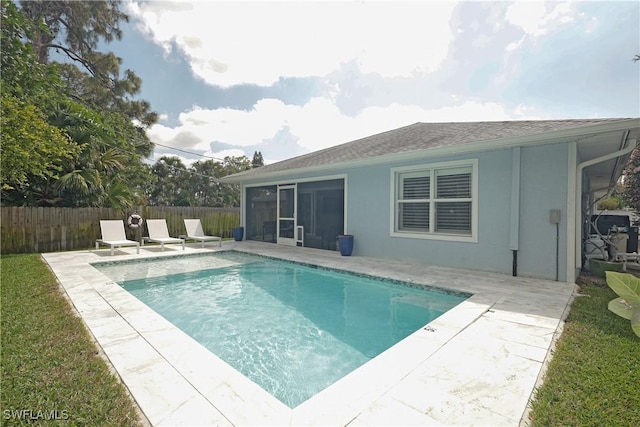 view of swimming pool with a fenced in pool, fence private yard, a sunroom, and a patio