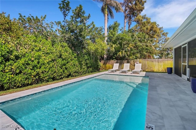 view of pool featuring a patio, a fenced backyard, and a fenced in pool