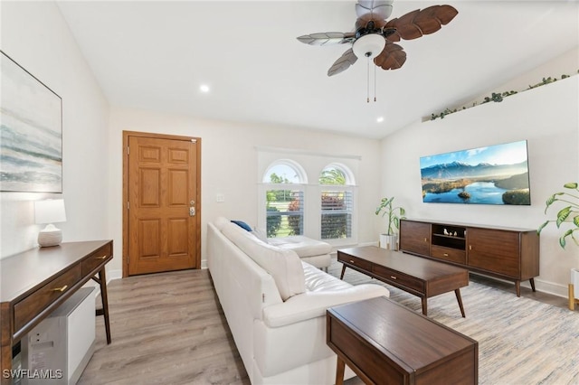 living area with baseboards, lofted ceiling, ceiling fan, light wood-type flooring, and recessed lighting