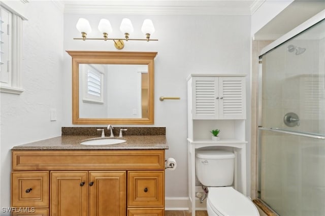 bathroom featuring ornamental molding, a stall shower, vanity, and toilet