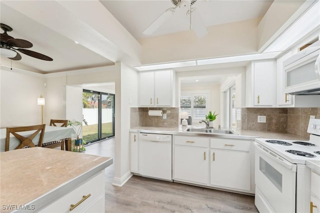 kitchen with light countertops, backsplash, a ceiling fan, a sink, and white appliances