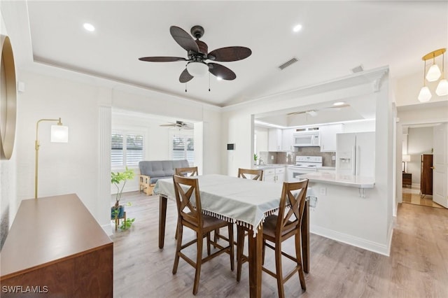 dining area featuring light wood finished floors, recessed lighting, visible vents, and baseboards