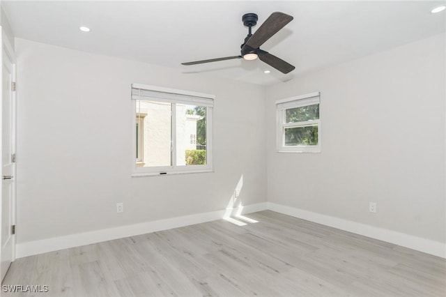 empty room with light wood-style floors, baseboards, a ceiling fan, and recessed lighting