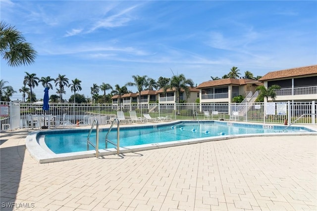 pool with fence and a patio