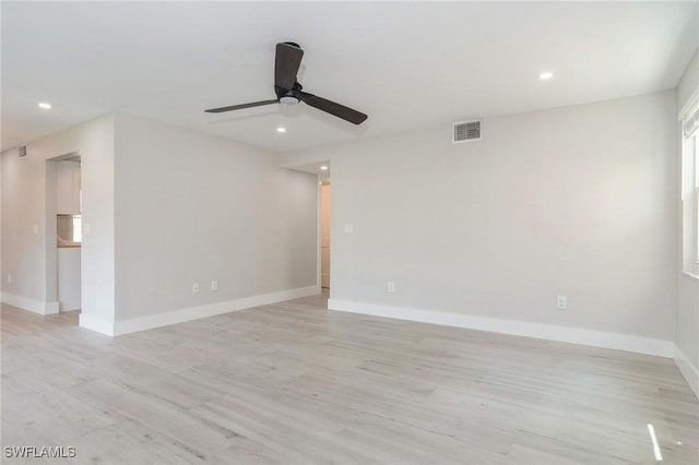 unfurnished room featuring light wood-style floors, recessed lighting, visible vents, and baseboards