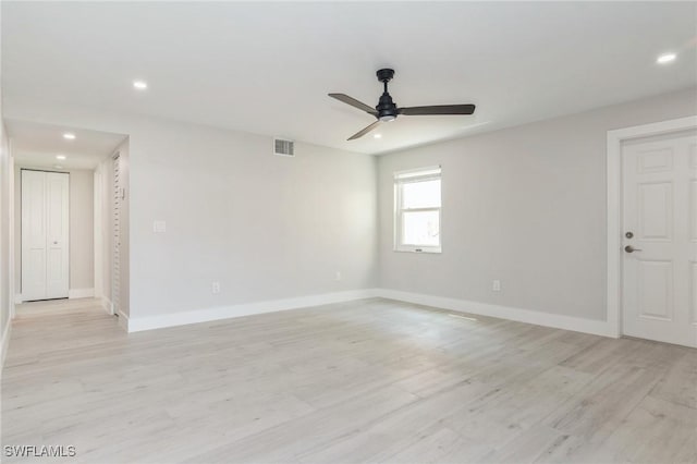 spare room with light wood-style flooring, visible vents, baseboards, and recessed lighting