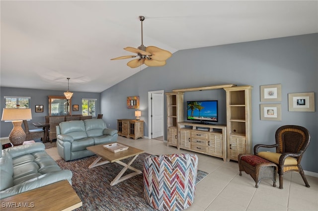 living room featuring ceiling fan, vaulted ceiling, baseboards, and light tile patterned floors