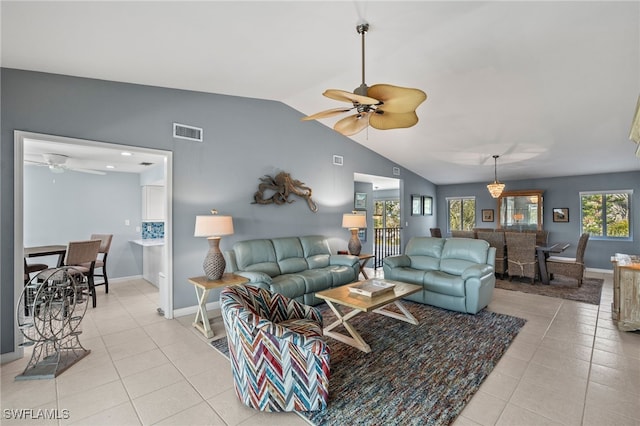 living room with lofted ceiling, visible vents, ceiling fan, and light tile patterned flooring