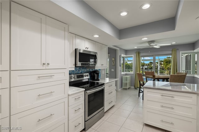 kitchen featuring stainless steel appliances, recessed lighting, white cabinets, and light tile patterned floors