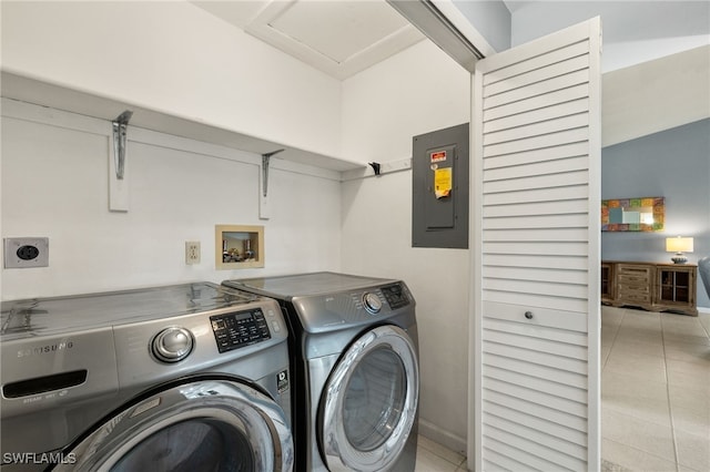 laundry room with light tile patterned floors, laundry area, baseboards, independent washer and dryer, and electric panel