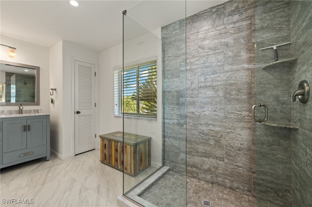 bathroom with baseboards, marble finish floor, vanity, a shower stall, and a closet