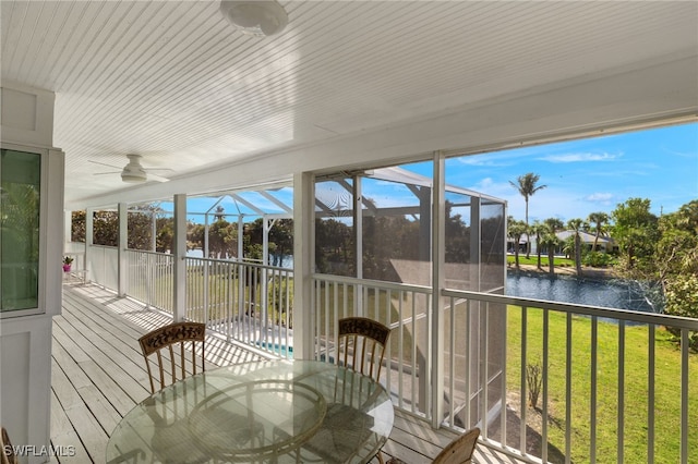 unfurnished sunroom featuring a water view