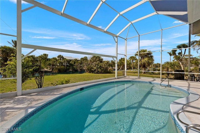 pool featuring glass enclosure, a yard, and a patio area