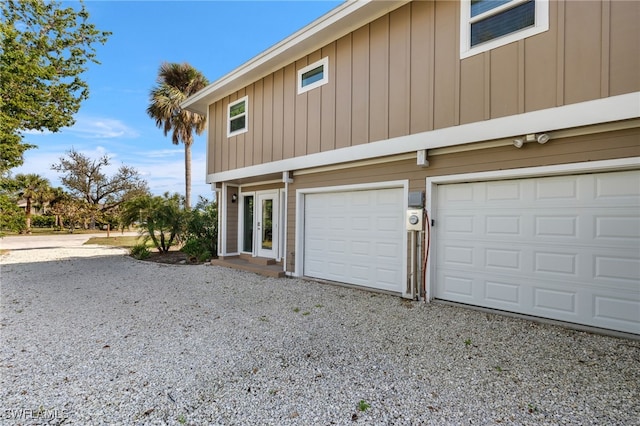 view of side of home featuring gravel driveway and board and batten siding