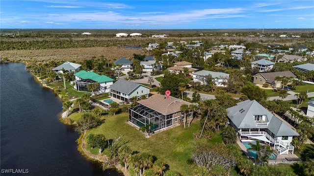 birds eye view of property featuring a residential view and a water view