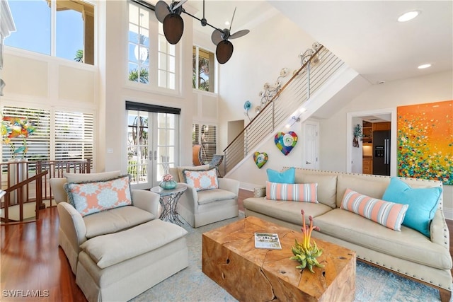 living room featuring ceiling fan, stairway, wood finished floors, french doors, and recessed lighting