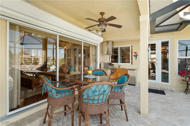 sunroom featuring ceiling fan