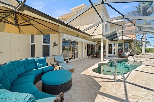 exterior space featuring glass enclosure, outdoor lounge area, and a patio