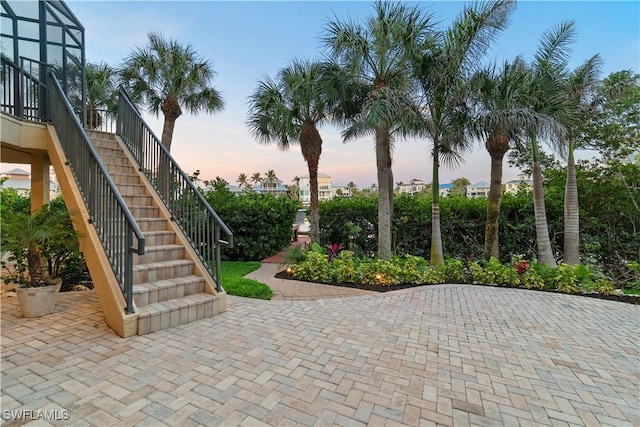 patio terrace at dusk featuring stairway