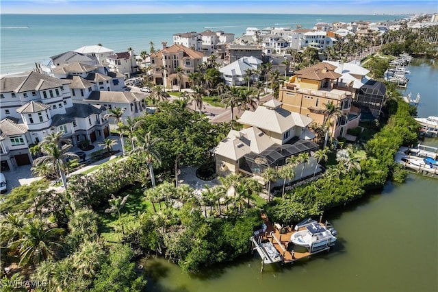 drone / aerial view featuring a residential view and a water view