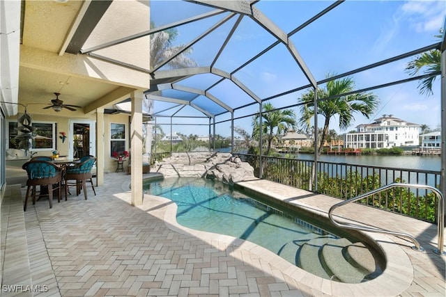 outdoor pool with ceiling fan, a lanai, a water view, a patio area, and outdoor dining space