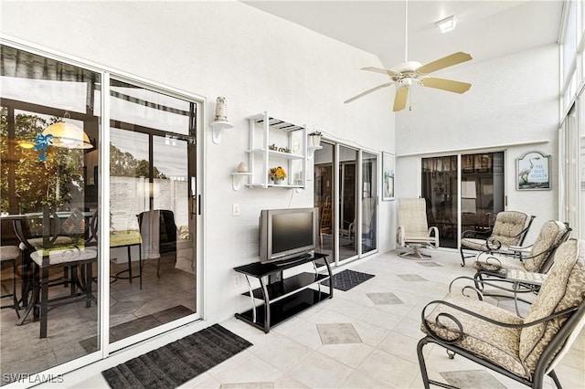 sunroom / solarium featuring ceiling fan