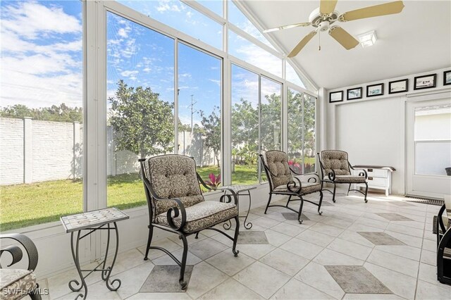 sunroom with lofted ceiling and ceiling fan