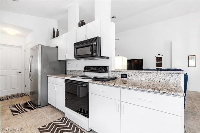 kitchen featuring black microwave, white cabinets, light stone counters, and range with electric stovetop