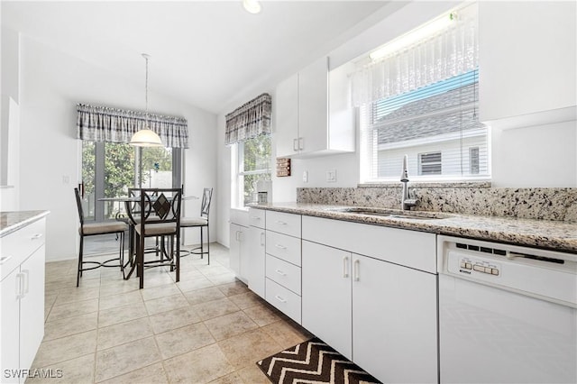 kitchen with pendant lighting, white cabinets, vaulted ceiling, a sink, and dishwasher