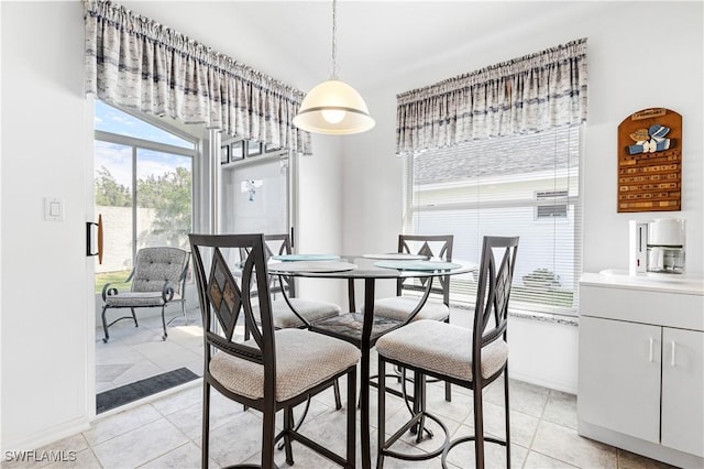 dining room featuring light tile patterned floors and baseboards