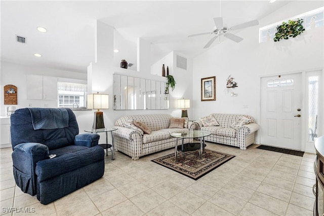 living area featuring recessed lighting, visible vents, a high ceiling, and light tile patterned floors