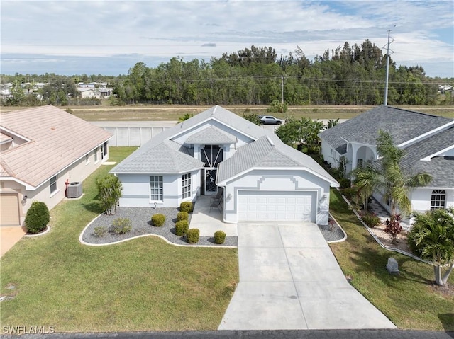 view of front facade featuring a garage, concrete driveway, roof with shingles, a front yard, and stucco siding