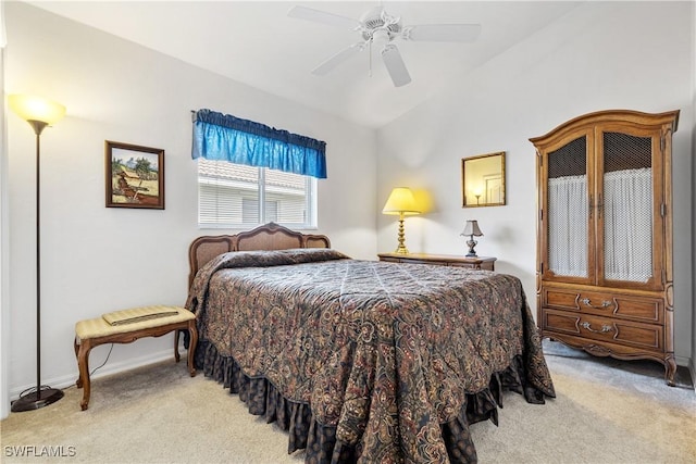 bedroom featuring light carpet, ceiling fan, baseboards, and lofted ceiling