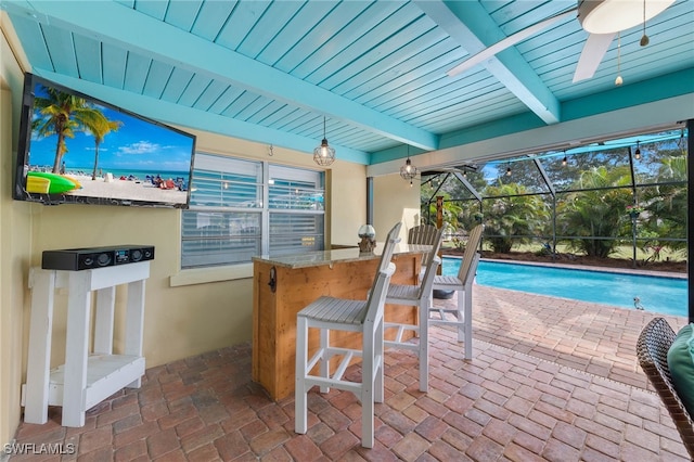 pool with a patio, a lanai, a ceiling fan, and outdoor dry bar