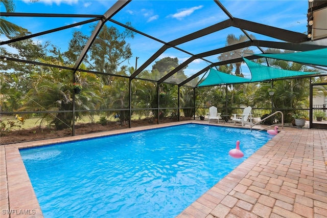 outdoor pool with a patio area and glass enclosure