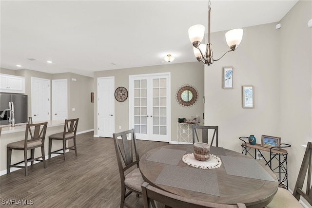 dining area featuring dark wood-style floors, french doors, recessed lighting, a chandelier, and baseboards