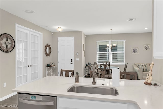 kitchen with light countertops, a sink, and stainless steel dishwasher