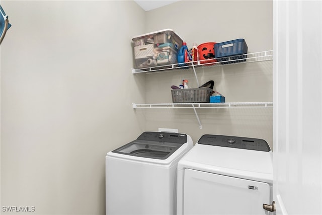 washroom featuring washing machine and dryer and laundry area