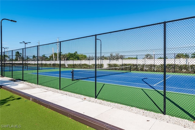 view of sport court with fence