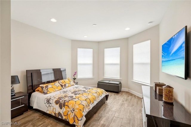 bedroom featuring recessed lighting, wood finished floors, and baseboards