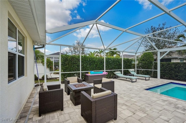 view of patio / terrace featuring a fenced in pool, an outdoor living space with a fire pit, and glass enclosure