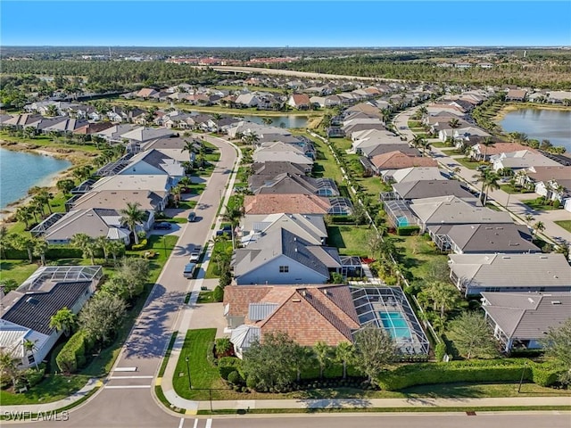 bird's eye view featuring a residential view and a water view