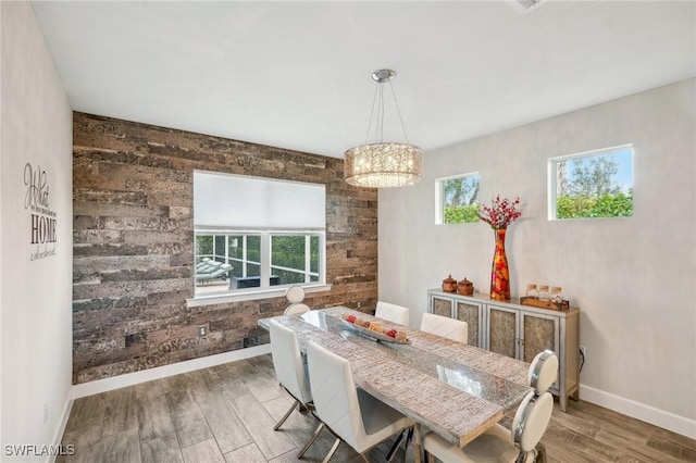 dining area featuring baseboards and wood finished floors