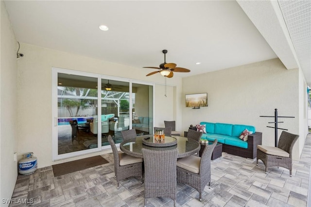 view of patio / terrace featuring ceiling fan, an outdoor living space, and outdoor dining space