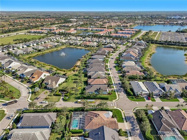 birds eye view of property with a water view and a residential view